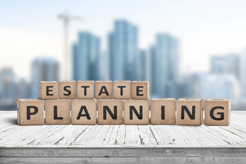 Estate planning sign on a wooden pier with tall buildings in the background